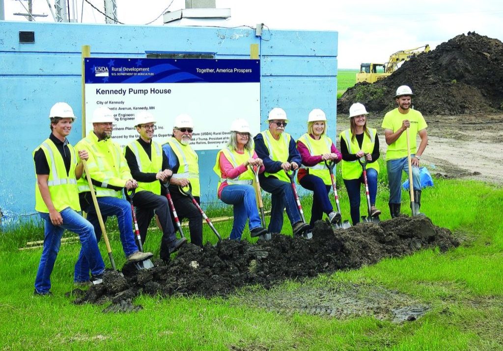 THE KENNEDY CITY COUNCIL gathered with a crew of Bollig, Northern Plains Contracting and USDA officials to break ground on the long-awaited water project. On Thursday, June 11, they took photos at the site. Pictured, above, Bollig representatives Nathan Gustafson, Cam Larson and Cade Krueger; City Councilors Henry Escareno, Jody Bowman, Mayor Earl Mattson, and Councilor Cindy Urbaniak, City Clerk Melissa Woinarowicz, and Blake Meyer of Northern Plains Contracting. Not pictured: Councilor Jon Turn, who regretfully, was unable to attend this daytime event. (Enterprise photo by Anna Jauhola)