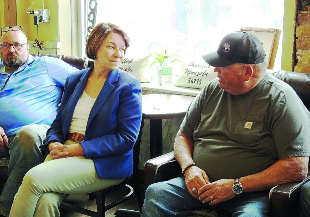 U.S. SEN. AMY KLOBUCHAR visits with Kittson County farmer Kelly Erickson during an informal meeting on Thursday, July 2 in Hallock. She made time for each person who attended the event, even one in the alleyway afterward. (Enterprise photo by Anna Jauhola)